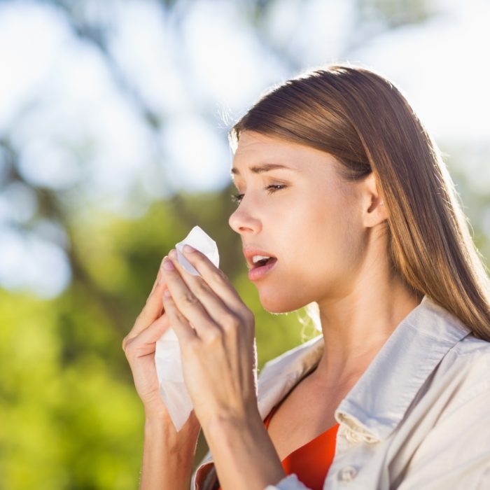 balloon sinuplasty recovery - women sneezes into tissue